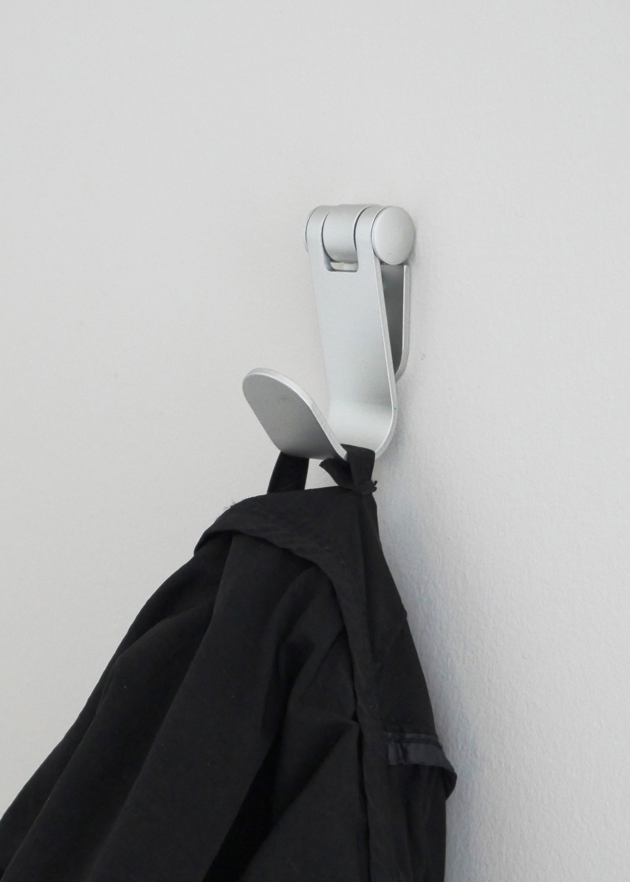 Metal wall hook holding jacket