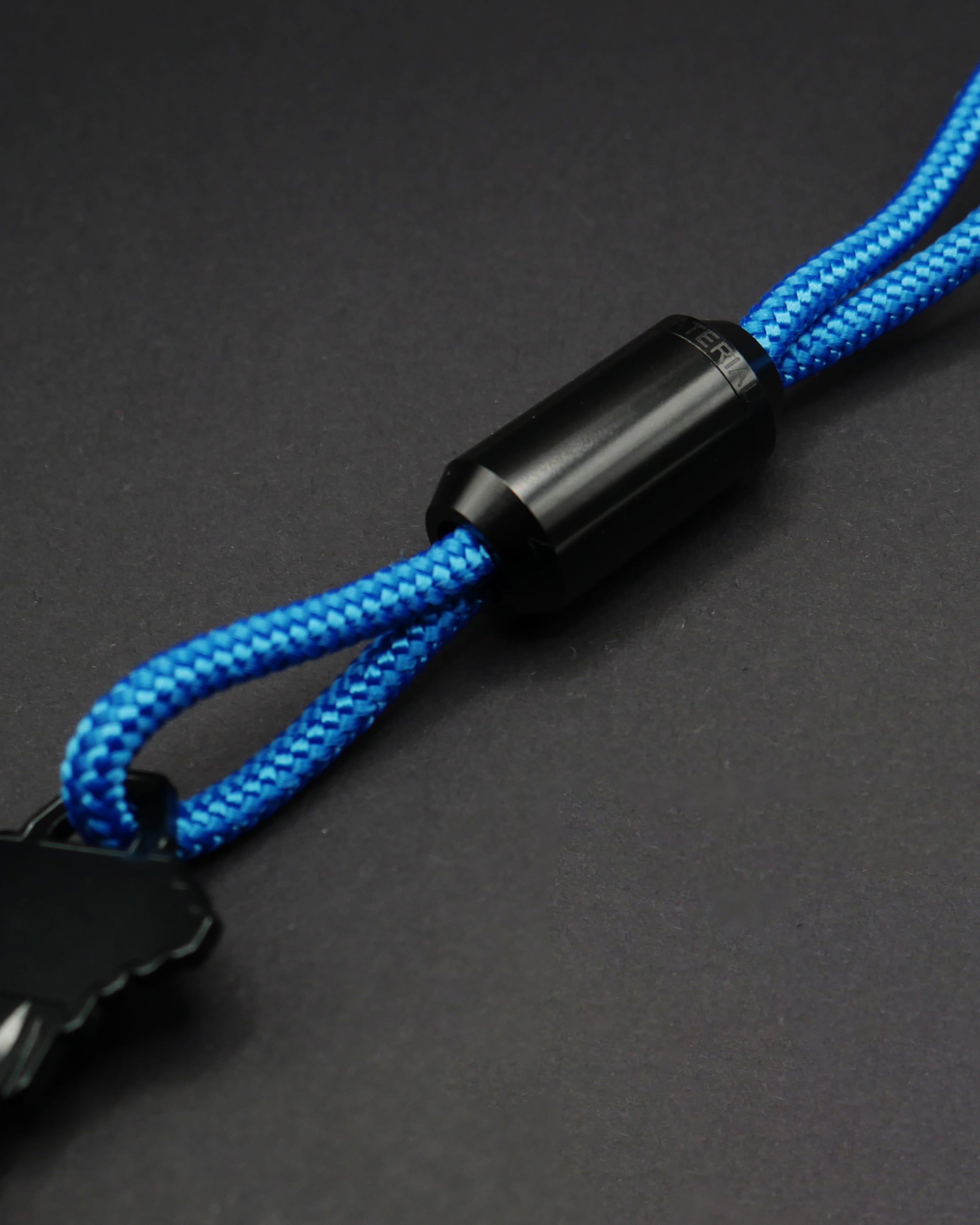 Keychain with black metal closure and blue nylon cord